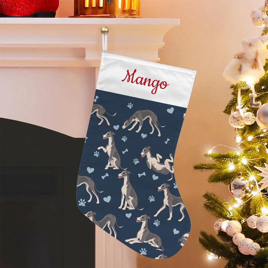 Whippet Christmas stocking on deep navy background with example name Mango in red script on the white cuff; view 1.