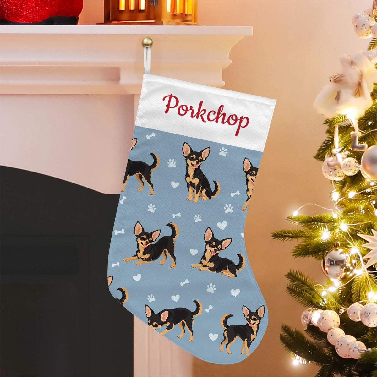 Chihuahua Black and Tan Christmas stocking on dusty blue background with example name Porkchop in red script on the white cuff; view 1.