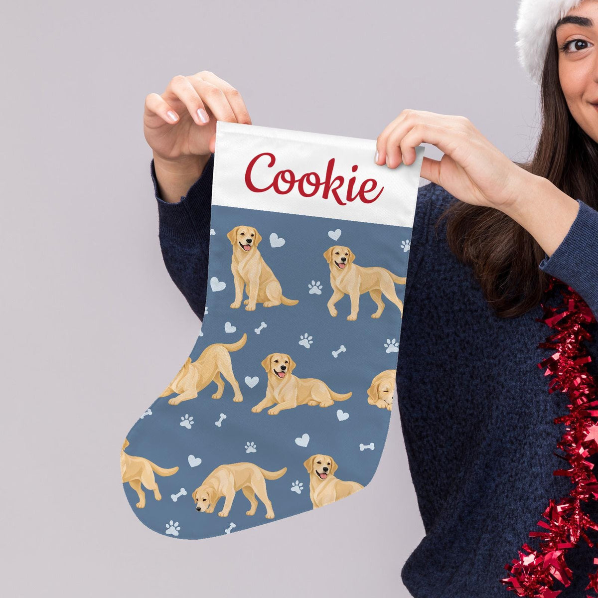 Labrador Retriever Yellow Christmas stocking on slate blue background with example name Cookie in red script on the white cuff; view 5.
