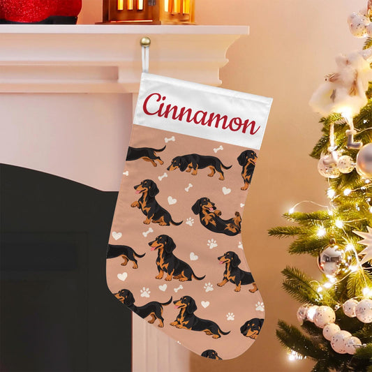 Dachshund Black and Tan Christmas stocking on peach background with example name Cinnamon in red script on the white cuff; view 1.