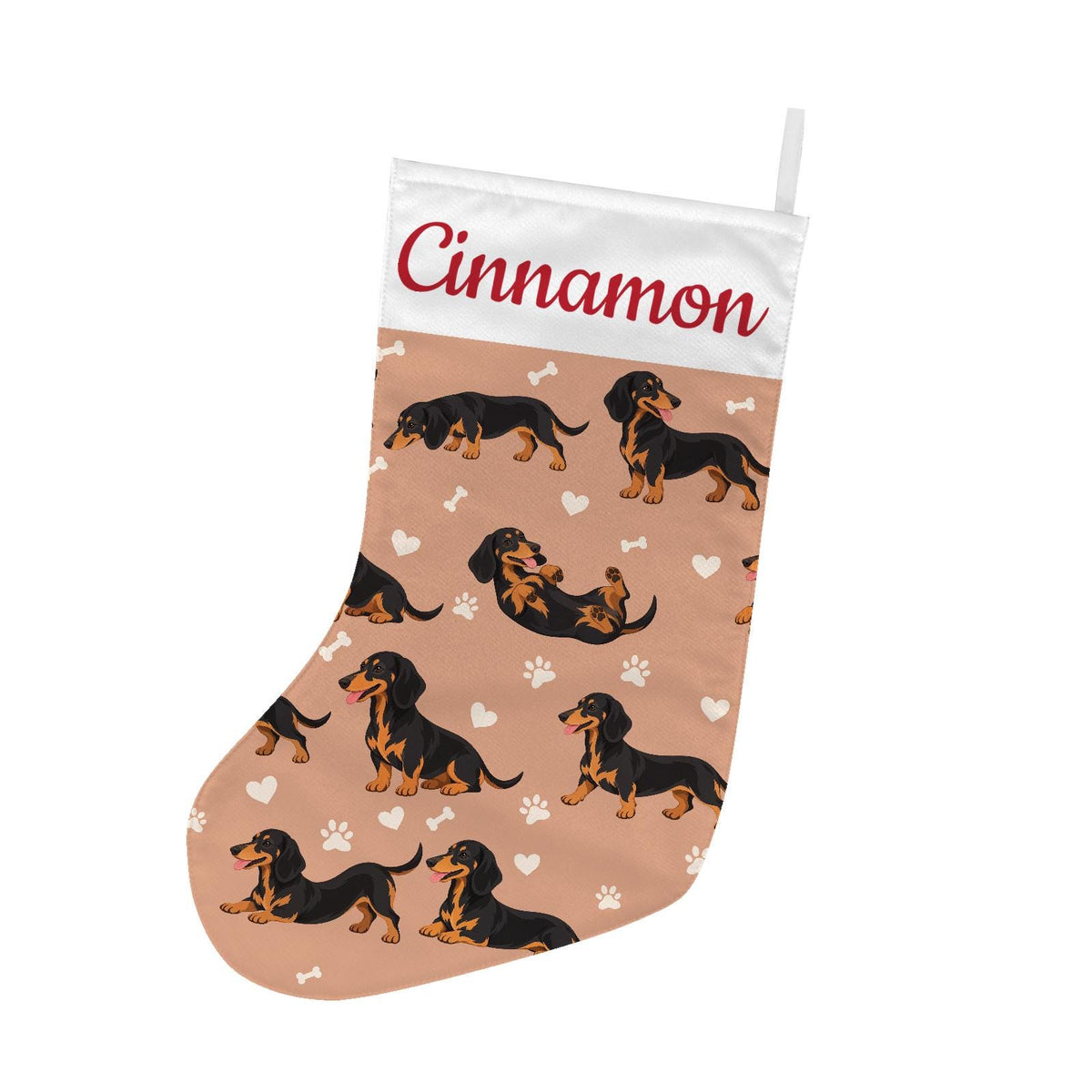 Dachshund Black and Tan Christmas stocking on peach background with example name Cinnamon in red script on the white cuff; view 2.