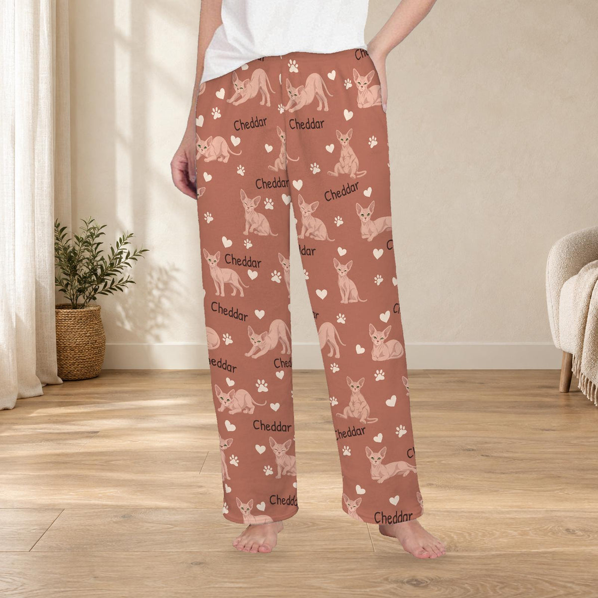 Sphynx personalized fleece pajama trousers on a model; women's fit, front view. Cozy neutral room background.