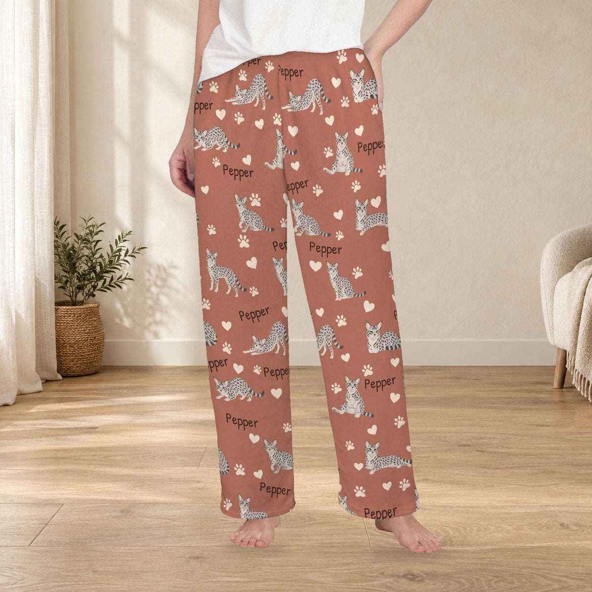 Egyptian Mau personalized fleece pajama trousers on a model; women's fit, front view. Cozy neutral room background.