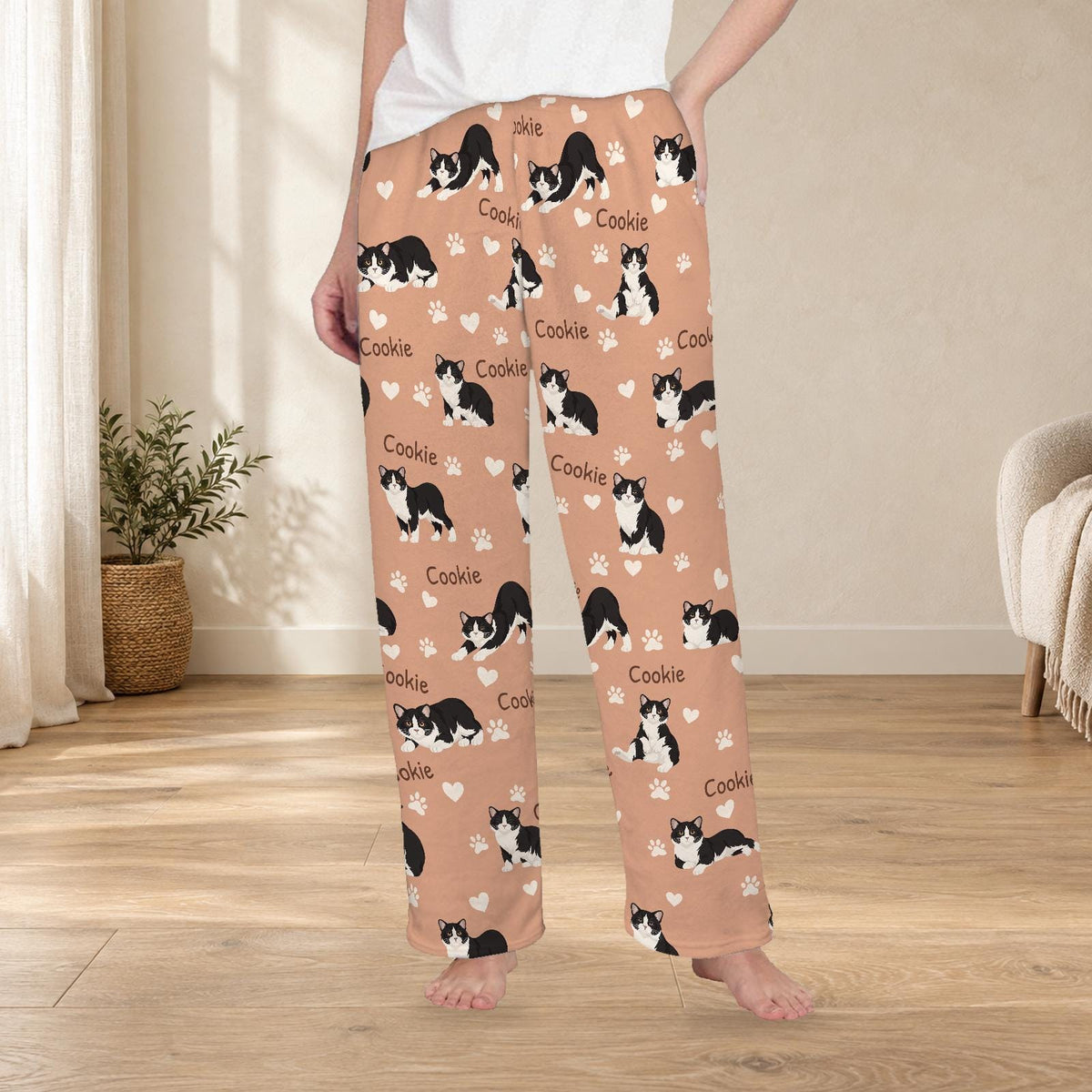 Manx personalized fleece pajama trousers on a model; women's fit, front view. Cozy neutral room background.