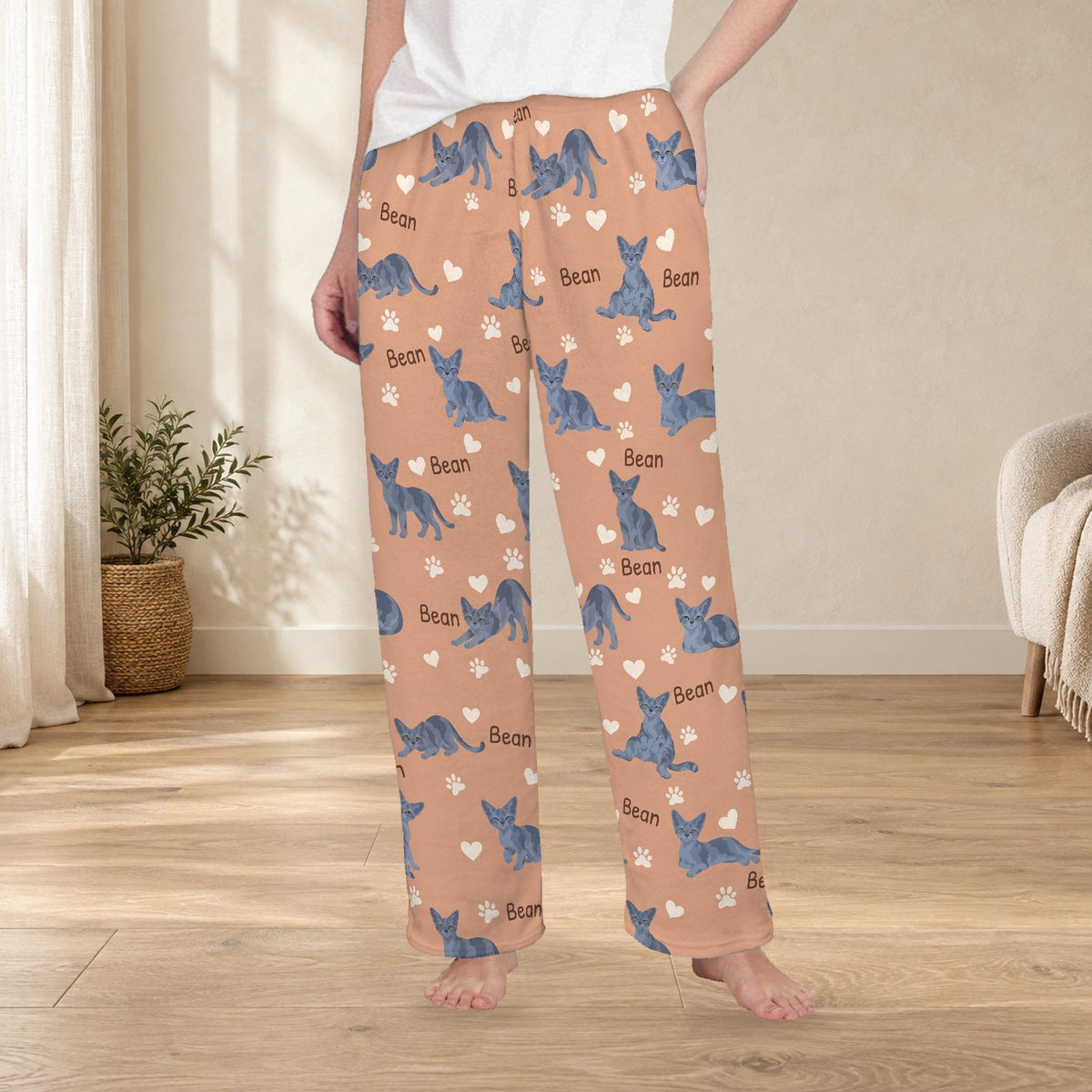 Devon Rex personalized fleece pajama trousers on a model; women's fit, front view. Cozy neutral room background.