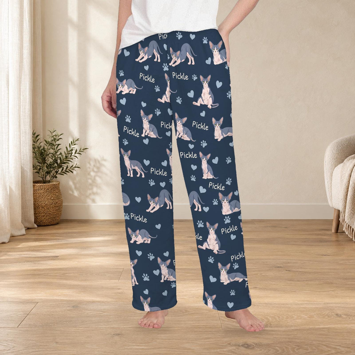 Sphynx personalized fleece pajama trousers on a model; women's fit, front view. Cozy neutral room background.