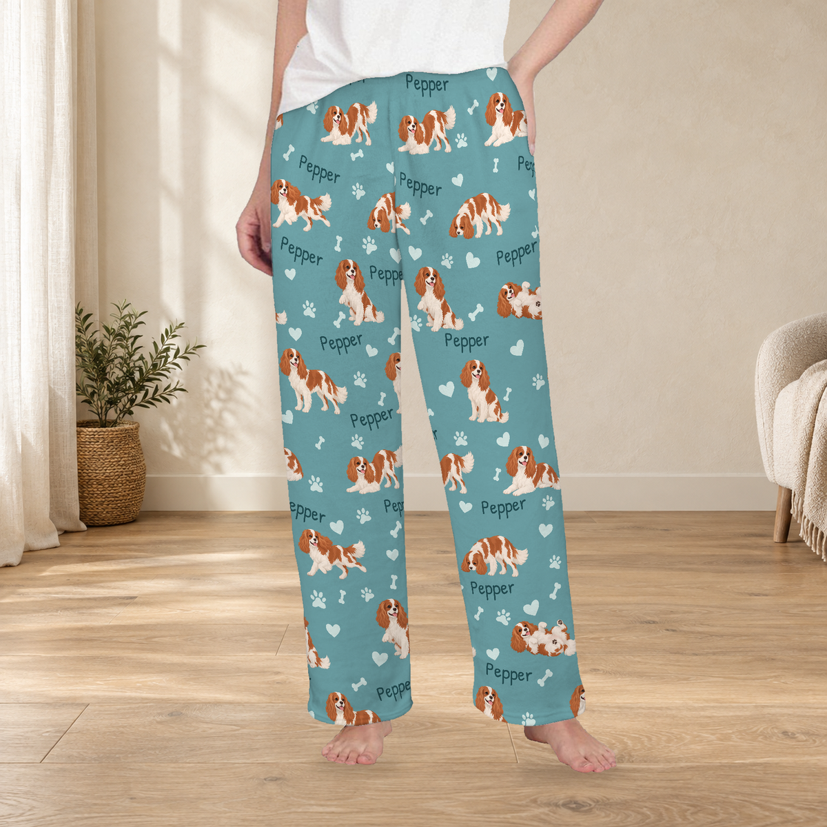 Cavalier King Charles Spaniel personalized fleece pajama trousers on a model; women's fit, front view. Cozy neutral room background.