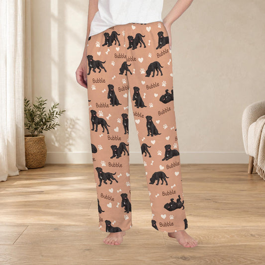 Cane Corso personalized fleece pajama trousers on a model; women's fit, front view. Cozy neutral room background.