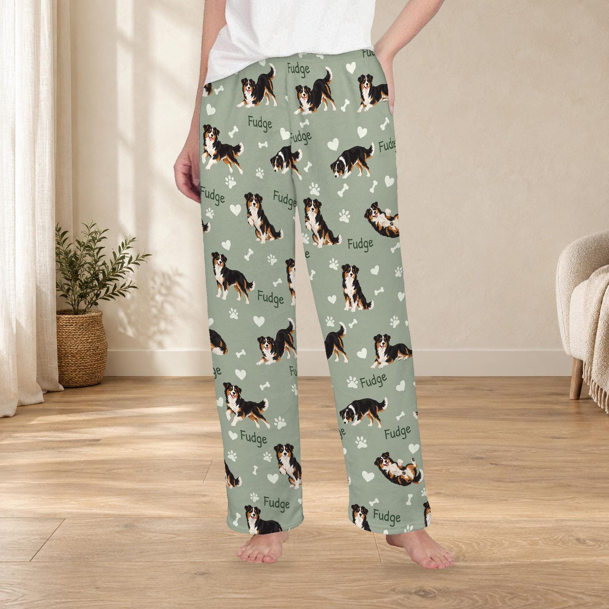 Miniature American Shepherd personalized fleece pajama trousers on a model; women's fit, front view. Cozy neutral room background.