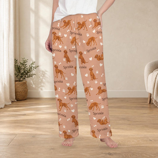 Vizsla personalized fleece pajama trousers on a model; women's fit, front view. Cozy neutral room background.