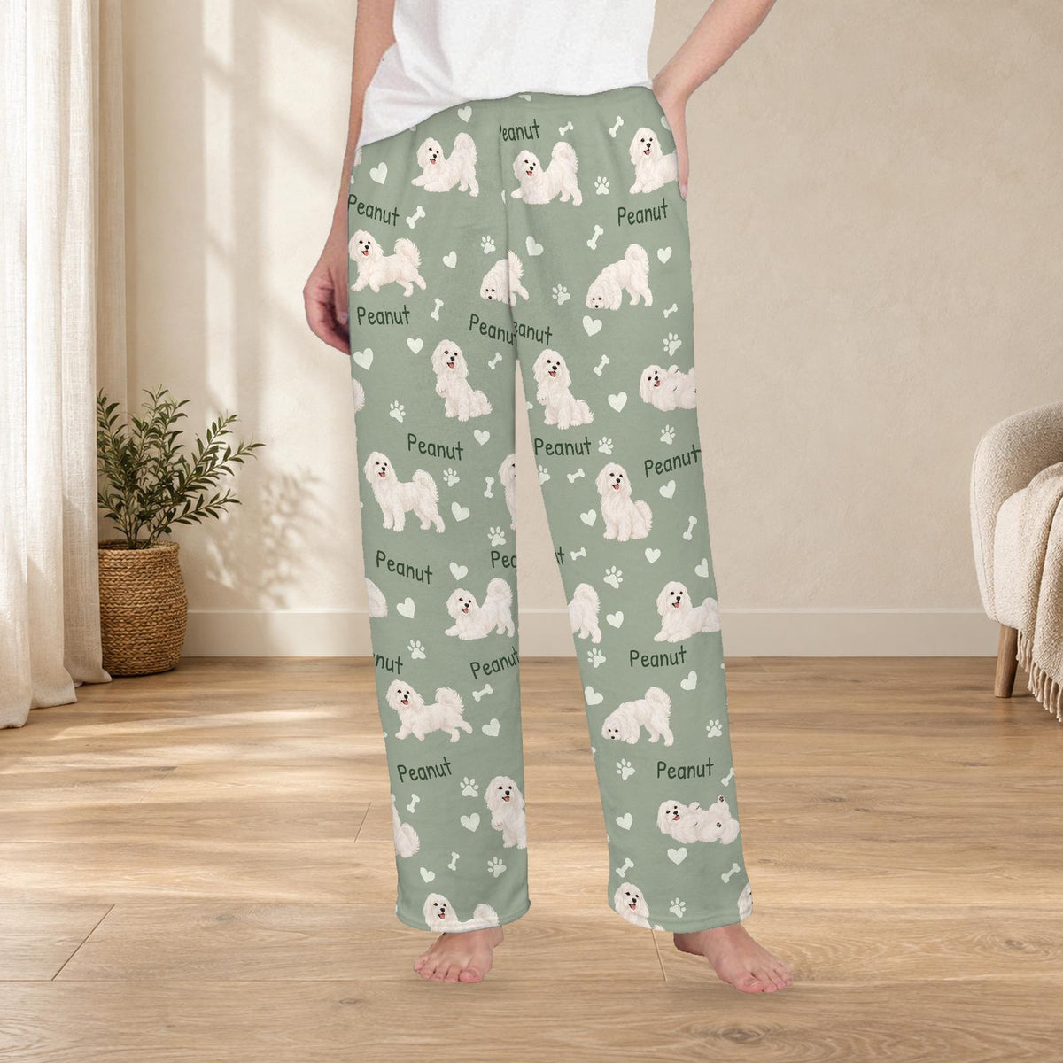 Maltese personalized fleece pajama trousers on a model; women's fit, front view. Cozy neutral room background.