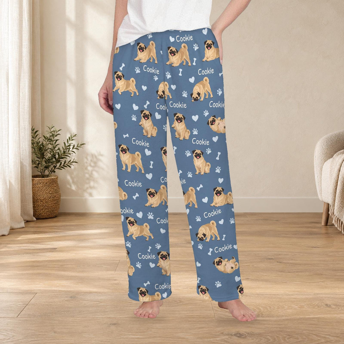 Pug personalized fleece pajama trousers on a model; women's fit, front view. Cozy neutral room background.
