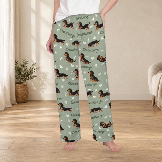 Dachshund Black and Tan personalized fleece pajama trousers on a model; women's fit, front view. Cozy neutral room background.